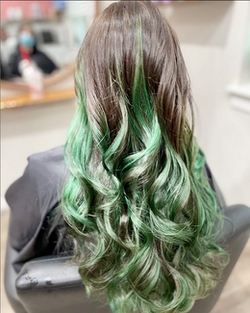 Glowy green hair coloration and styling by Naomi Meadowcroft